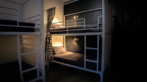 a room with two bunk beds in a dark room at Brisbane Quarters in Brisbane
