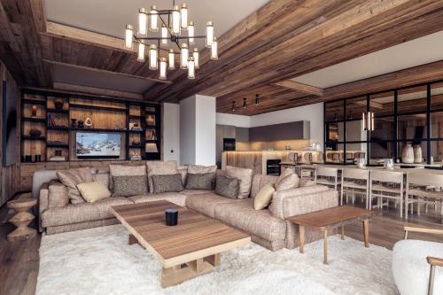 a living room with a couch and a table at Antarès SIRIUS 201 - Prestigious ski inski out apartment in Méribel