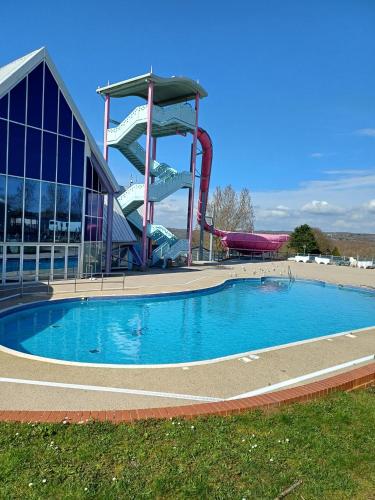 a swimming pool with a water slide in front of a building at 3 Bedroom Caravan - Sleeps 8 Parking Pets Beach in Hastings