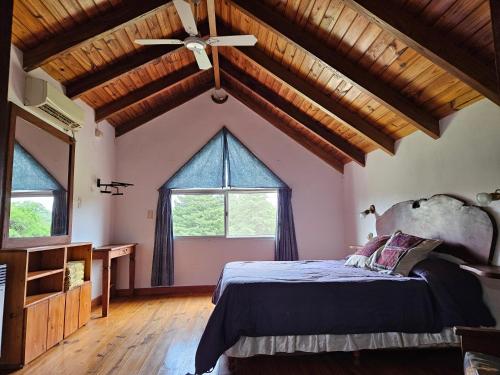 una camera da letto con un letto e un ventilatore a soffitto di Tinkuy a Molinari