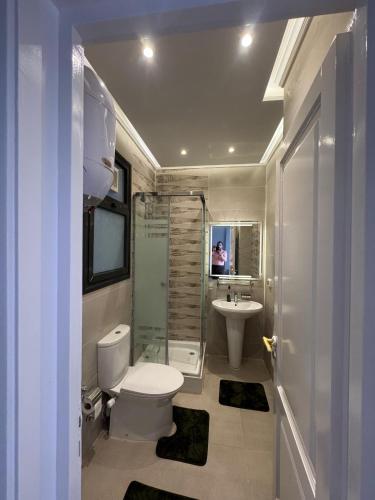 a bathroom with a toilet and a sink at Celia -1 Bedroom Beauty in Madīnat al Amal
