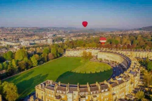 a hot air balloon flying over a castle at 2 bed cottage nr Glastonbury festival, Frome, Bath in Shepton Mallet