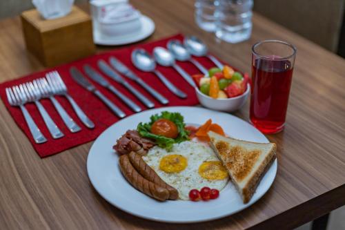 a plate of breakfast food with eggs and toast at Hotel Verandah in Itahari