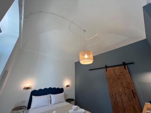 a bedroom with a bed with a blue head board at Dimora NONNA CATERINA in Monopoli