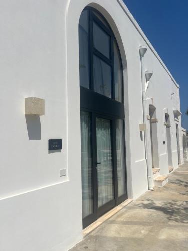 a white building with large windows on the side of it at Dimora NONNA CATERINA in Monopoli
