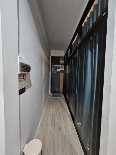 a hallway with a toilet in a room at K Siri House Hatyai in Hat Yai
