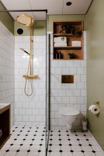 a bathroom with a shower and a toilet at Haga Slott in Enköping