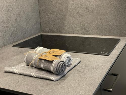 a bunch of towels on a counter in a kitchen at Lakeview Modern Karaim Cottage Trakai in Trakai