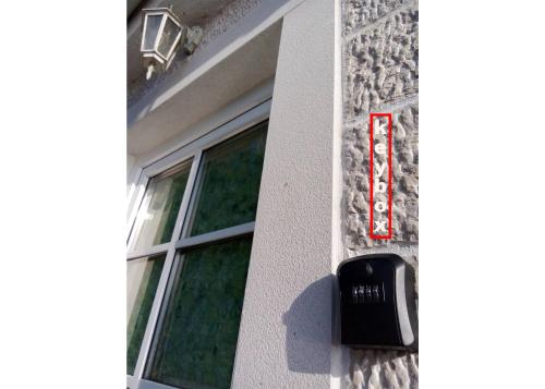 a window on a building with a sign on it at Apartment Mediterraneo Blue Sky in Perast