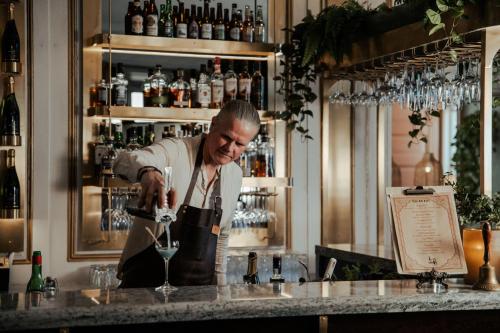 a man is preparing a drink in a bar at Haga Slott in Enköping