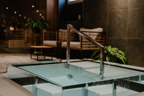 a glass table in a lobby with a chair at Haga Slott in Enköping