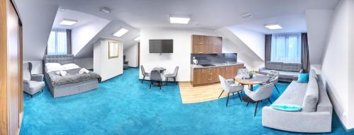 a living room with a room with blue carpet at Celestynka in Rymanów-Zdrój