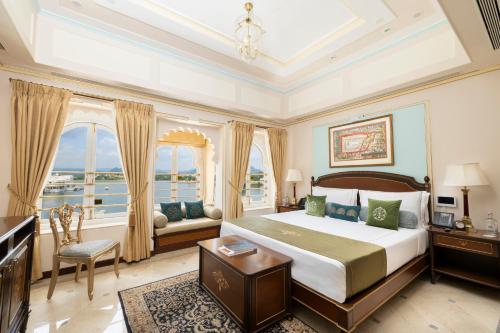 a bedroom with a large bed and a large window at Taj Fateh Prakash Palace Udaipur in Udaipur