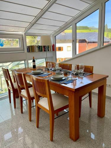 a dining room with a table with wine glasses at Villa Aigner in Achenkirch