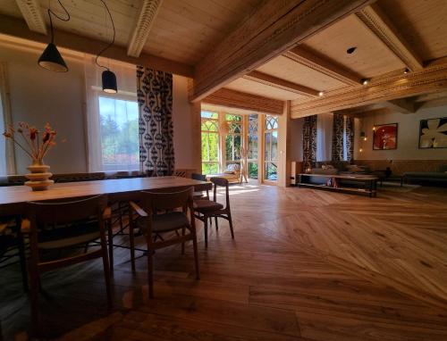 a dining room with a large wooden table and chairs at Willa Storczyk Asnyka Centrum in Zakopane