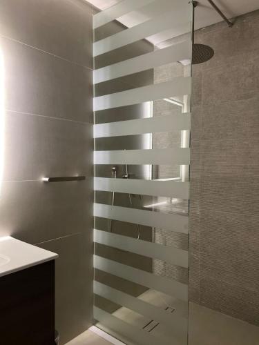 a shower with a glass door in a bathroom at 101 - Comfy Space - 80TV smart - Self Check-in in Riyadh