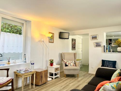 a living room with a couch and a chair at COC - La Cabine in Wissant