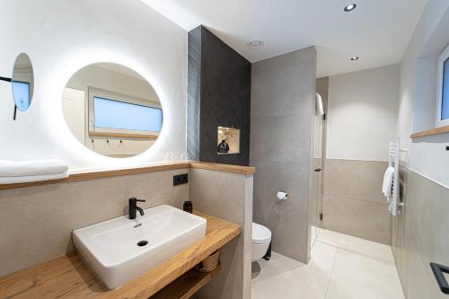 a bathroom with a sink and a mirror at See und Sporthotel Ankum mit Lakeside Apartments in Ankum