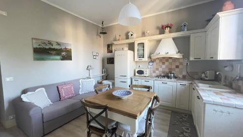 a kitchen and living room with a couch and a table at Casa Lenzona in Certaldo