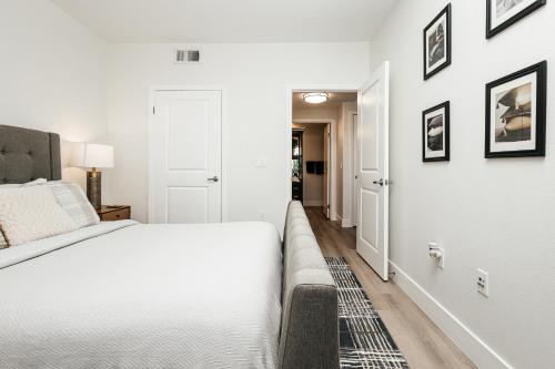 a white bedroom with a bed and a hallway at Central Quality 2 BD Apartment in Los Angeles