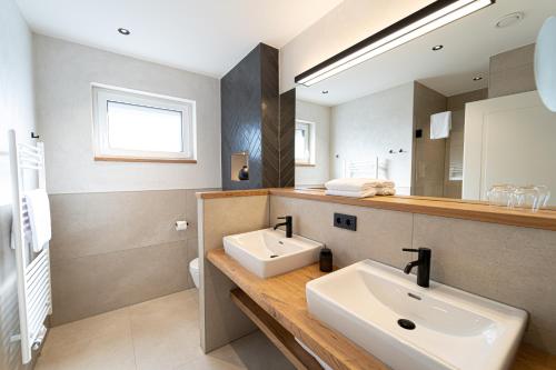 a bathroom with a sink and a mirror at See und Sporthotel Ankum mit Lakeside Apartments in Ankum