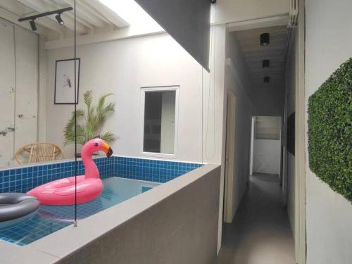 a swimming pool with a pink flamingo in a bathroom at Heritage House 2BR with Dipping Pool in Town walkto Street Art 45 in George Town