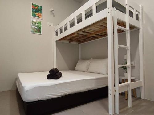 a white bunk bed with a teddy bear sitting on it at Heritage House 2BR with Dipping Pool in Town walkto Street Art 45 in George Town