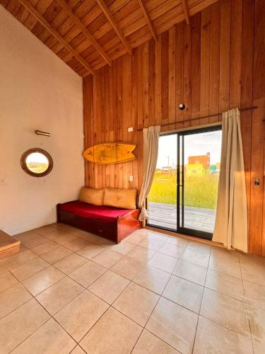 a room with a bed with a surfboard on the wall at AMARRA Camet Norte in Camet Norte