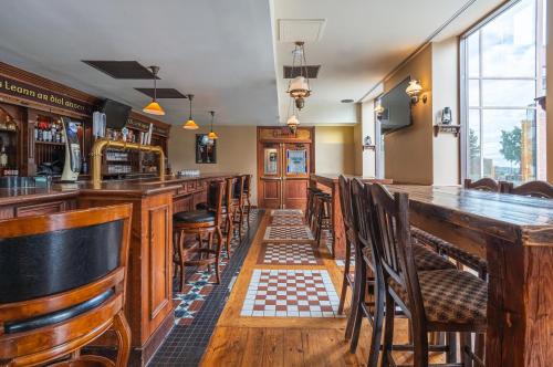 a bar with wooden tables and chairs in a pub at DEV Hotel and Conference Centre in Cornwall