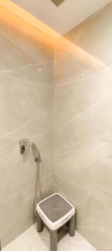 a white bathroom with a toilet in a room at Belle-Vue Holiday Homes - 1BHK Apartments in Panchgani