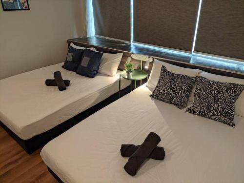 a bedroom with two beds with crosses on them at Heritage House 2BR in Town walkto UNESCO Site & StreetArt 45 in George Town