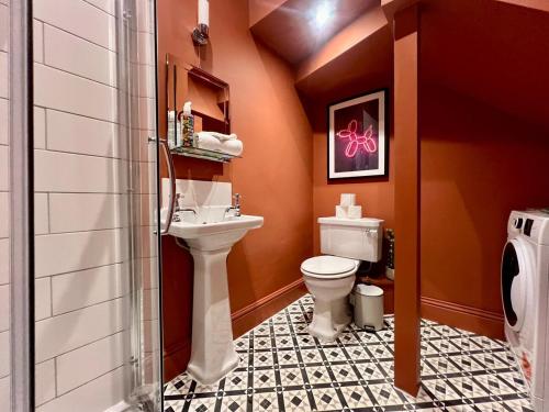 a bathroom with a toilet and a sink at Stylish Victorian Home - Central Frome in Frome