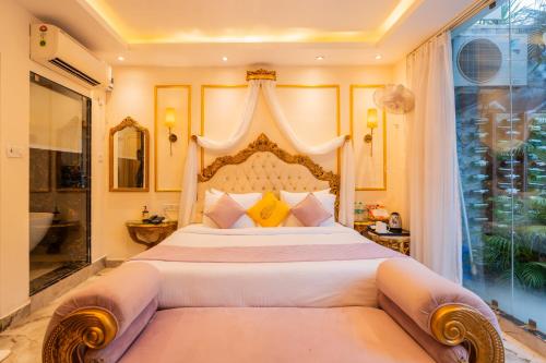 a bedroom with a large bed with a large headboard at Emperor Ozran by Alaya Stays in Vagator