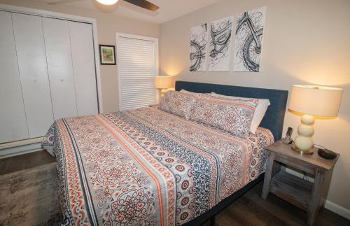 a bedroom with a bed and a table with a lamp at LB207A Newly Renovated Family Friendly Washer Dryer Fireplace WiFi EZ Parking in Snowshoe