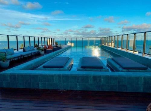 a swimming pool on the roof of a building at Flat a 50m Praia Caribessa - Get One in João Pessoa