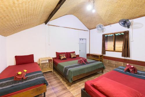 a room with two beds in a tent at Family Song Koh Lipe in Ko Lipe