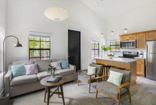 a living room with a couch and a kitchen at La Siesta Resort & Villas in Islamorada