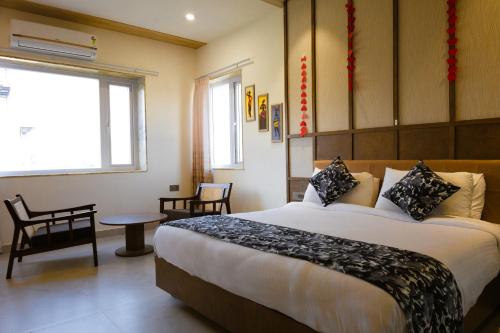 a bedroom with a large bed in a room at Akaya Hills in Udaipur