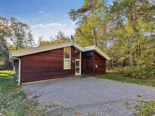 a small house with a parking lot in the woods at Holiday Home Sakarias - 800m from the sea by Interhome in Hasle