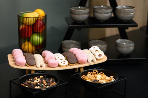 two plates with different types of donuts and bowls of food at Hotel Bristol Budapest in Budapest