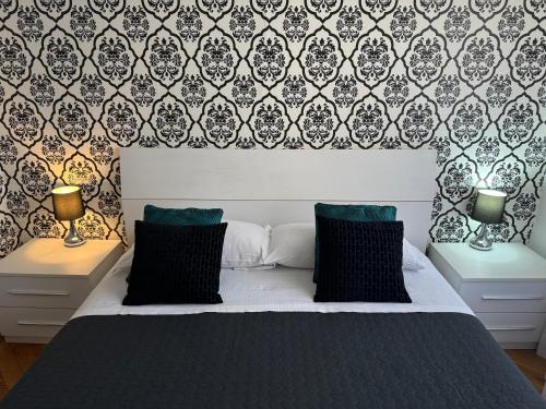 a bedroom with a bed and two nightstands with lamps at Flaminio Holidays in Rome