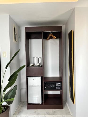 a room with a cabinet with a appliance in it at I - scape in Subic