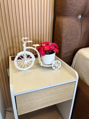 a small table with a bike and flowers on it at I - scape in Subic