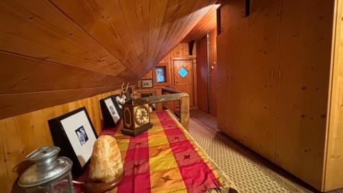 a room with a bed in a wooden house at Almhaus Sparwald in Teuchl