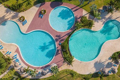 an overhead view of two large swimming pools at Eagle Beach-Best value-Island View 1BR condo-R362 in Palm-Eagle Beach