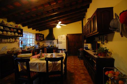 a kitchen with a table with chairs and a ceiling at Finca Cielo Verde in Chicoana