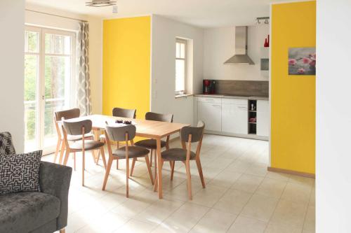 a kitchen and dining room with a table and chairs at Villa Liselotte in Fürstenberg