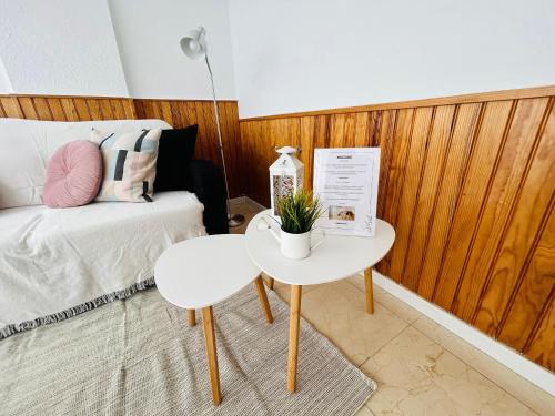 a small table with a plant on it next to a bed at Tabaiba views in Tabaiba