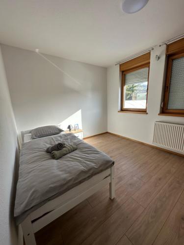 a bedroom with a bed and a window at Apartman Vidić 2 in Požega