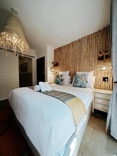 a bedroom with a large white bed in a room at Beachwood Camps Bay in Cape Town